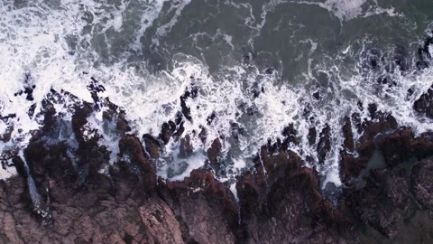 Abstract top down foamy ocean waves crashes rock Stock Footage 224106946