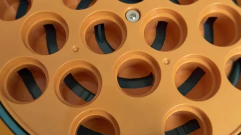 Abstract top-down view of an orange industrial machine with a circular sorting Stock Footage 321700317