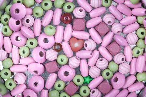Abstract top view macro background of pink and green beads Stock Photos