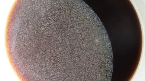 Abstract top view on surface of coffee in white mug Stock Footage 74897705