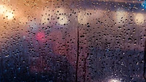 Abstract traffic in raining day. View from car seat. Rainy days, Rain drops.. Stock Photos