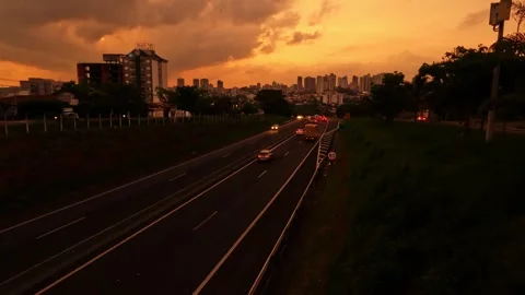 Abstract trail of light caused by vehicular traffic in Highway with buildings Video stock 263983445
