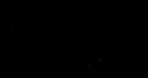 Abstract trails of particles fly along a curved trajectory against a black b Stock Footage 325740279