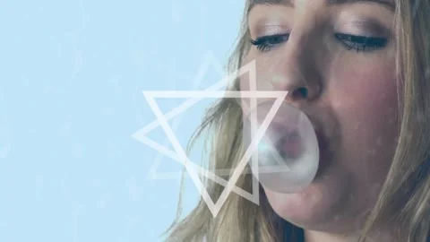 Abstract triangular spinning against close up of caucasian woman blowing a Stock Footage 325770453