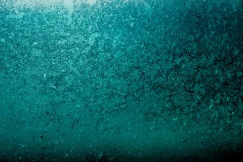 Abstract turquoise background from frosty pattern on glass Stock Photos