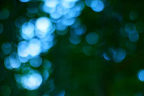 Abstract turquoise light bubbles on dark green background representing unde.. Stock Photos