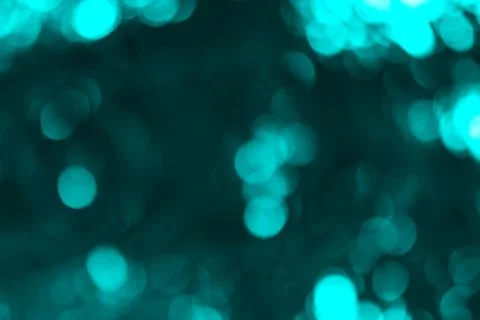 Abstract Turquoise Light Bubbles on a Deep Teal Background creating a magic.. Stock Photos