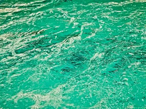 Abstract Turquoise Water Surface Texture with Foam and Dynamic Ripples Stock Photos