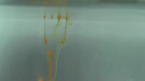 Abstract Two Yellow Drops Of Color Liquid Into Water Video stock 22634778