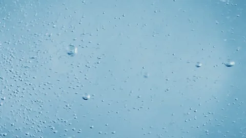 Abstract underwater motion of tiny air bubbles rising through clear blue li.. Stock Footage 337347821