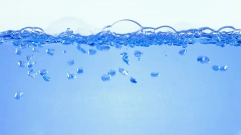 Abstract underwater view with rising air bubbles and surface ripple motion .. Stock Footage 337349930