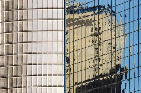 Abstract urban reflection with distorted architecture on glass high-rise faca Stock Photos