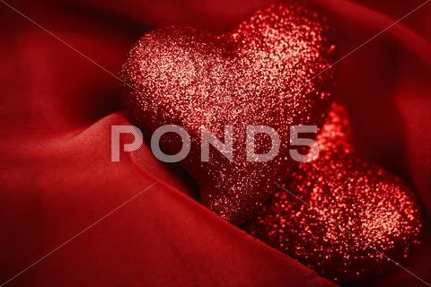Abstract valentine's backgrounds over red textile with tho hearts Stock Photos
