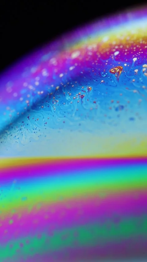 Abstract Vertical Macro Shot of Spherical Rainbow Iridescence on Soap Bubble Stock Footage 334109853