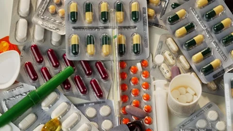 Abstract video of a thermometer on which pills fall, slow motion video. Stock Footage 278829680
