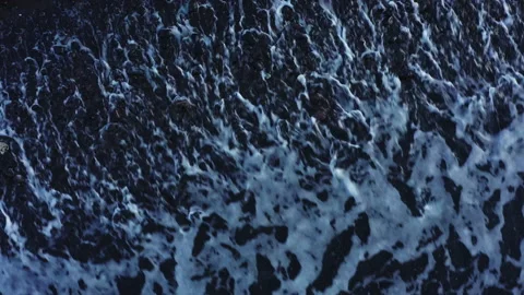 Abstract view from above of waves breaking along rocky beach Stock Footage 141345750