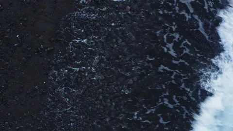 Abstract view from above of waves breaking along rocky beach Stock Footage 141346059