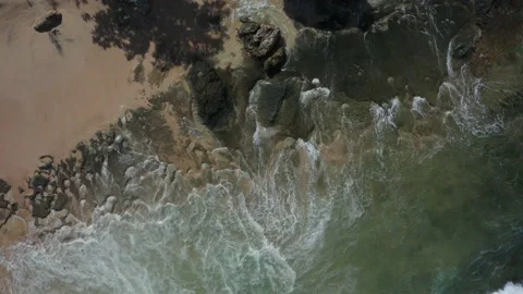 Abstract view from above of waves breaking along rocky beach Stock Footage 142243701