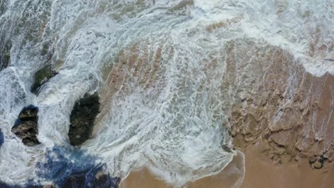 Abstract view from above of waves breaking along rocky beach Stock Footage 142244433