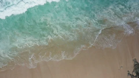Abstract view from above of waves breaking along a beach Stock Footage 142245425