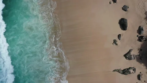 Abstract view from above of waves breaking along a rocky beach Stock Footage 142245738