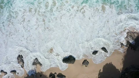 Abstract view from above of waves breaking along a rocky beach Stock Footage 142245888