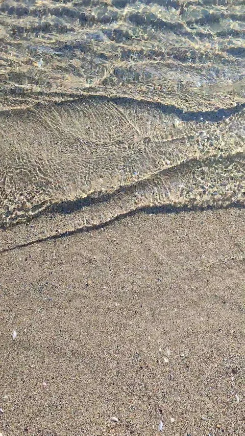 Abstract view of clean transparent water small sea wave rolling sand sandy beach Stock Footage 294638254