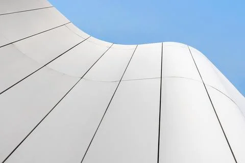 Abstract view of a modern white building facade with smooth curved panels Stock Photos