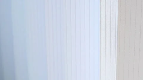 Abstract view of moving white window blinds in soft breeze Stock Footage 338332759
