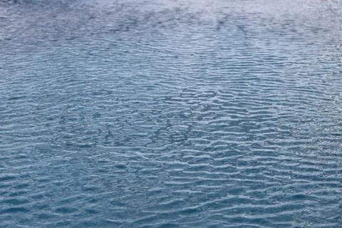 Abstract view of rippling water surface with subtle blue tones and textures Stock Photos