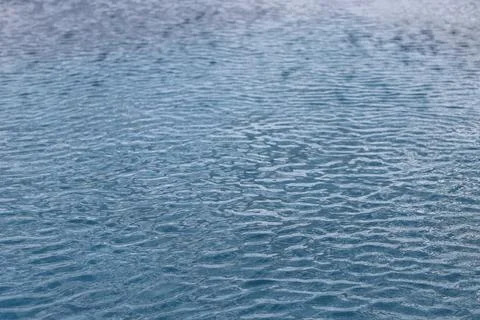 Abstract view of rippling water surface with soft blue hues and gentle waves Stock Photos