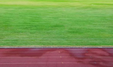 Abstract View Of Running Track And Green Field Stock Photos