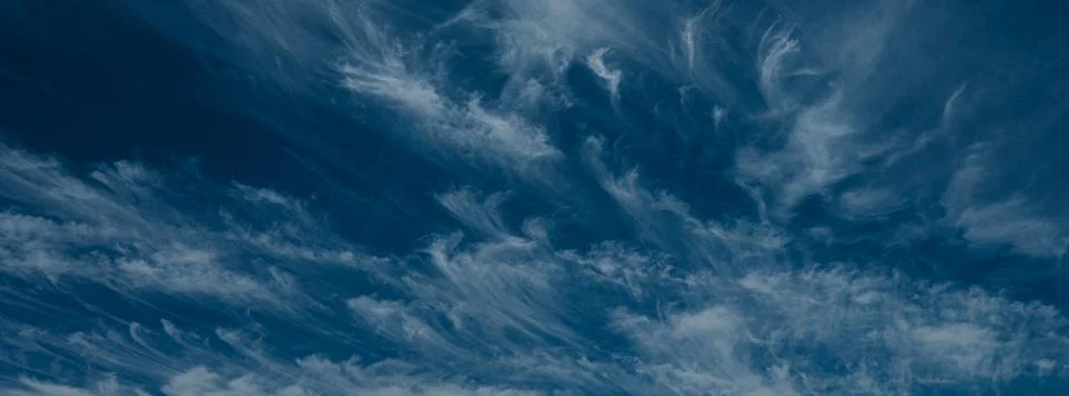 An abstract view of thin, faint clouds drifting across. Stock Photos