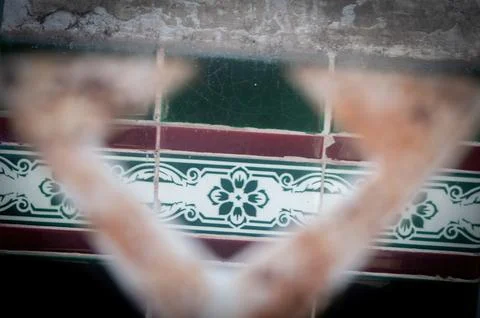 An abstract view through an out of focus archway reveals a wall adorned wit.. Stock Photos