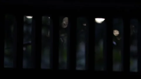 Abstract View Through Vertical Bars at Night with Blurred Outdoor Lights Stockbeeldmateriaal 313062163