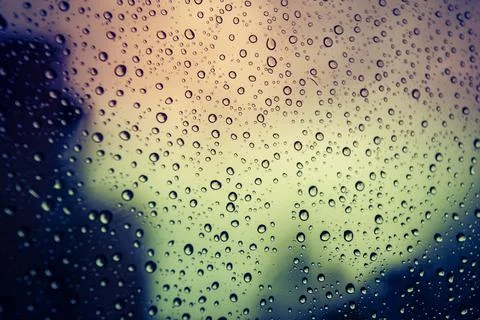 Abstract view of water droplets on glass. Retro and vintage toning effect. Stock Photos