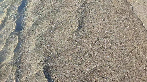 Abstract view waves clean transparent water of the sea on the sand of the beach Stock Footage 291651504