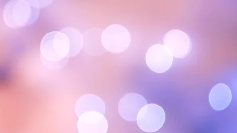 Abstract violet bokeh lights on defocused pale peach background Vidéo 100229608