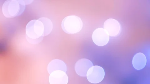 Abstract violet bokeh lights on defocused pale peach background Vídeos de archivo 100229617