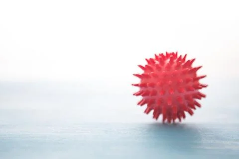 Abstract virus strain red model of Coronavirus disease COVID-19 on blue wooden 스톡 사진