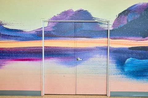 Abstract wall art creating sunset mountain scene with a door in the middle Fotos Stock