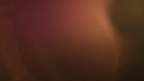 Abstract warm flare light glows over a dark background Stock Footage 106348988