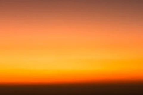 Abstract warm gradient sky at sunset with soft blur and glowing orange-to-y.. Stock Photos