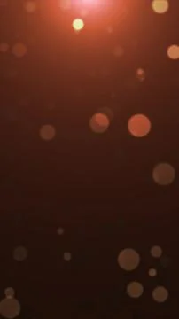Abstract warm orange bokeh background with soft glowing circles floating on a Stock Illustration