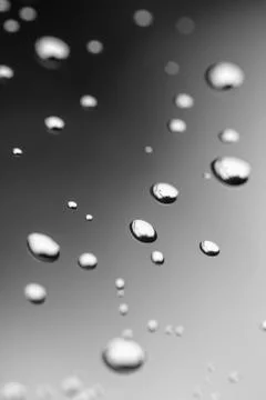 Abstract water drops on plain background, black and white photography Stock Photos