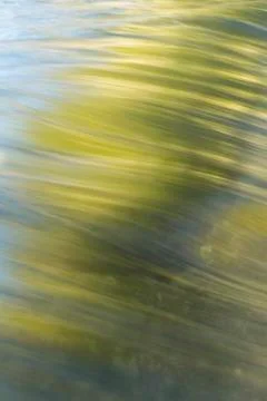Abstract water with fall color reflections long exposure smoothly flows Stock Photos