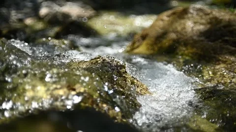 Abstract water from a mountain stream in summer sunglight (slow motion) 스톡 동영상 260836396