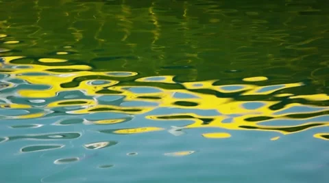 Abstract water reflections (blue-yellow-green) from yellow boat Stock Footage 62644957