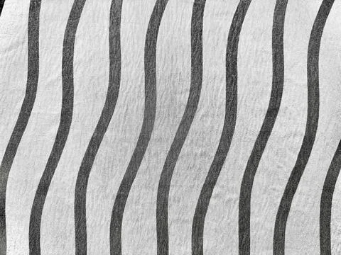 Abstract wavy black stripes texture on soft white fabric evoking rhythmic flu Stock Photos