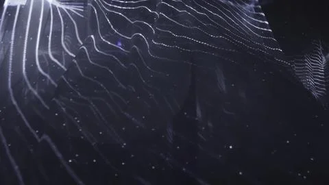 Abstract wavy surface gently moving with particles on dark background. Action Stock Photos